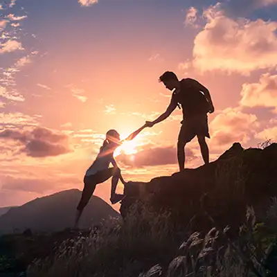  A person helping another one up a hill