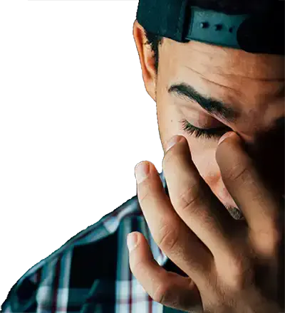  A young man holding his head in his hand.