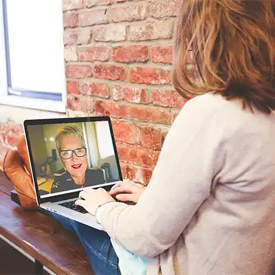  Online Addiction Recovery Coaching – woman on a computer.