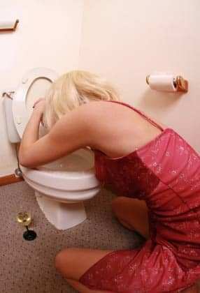 Alcohol poisoning - woman vomitting.